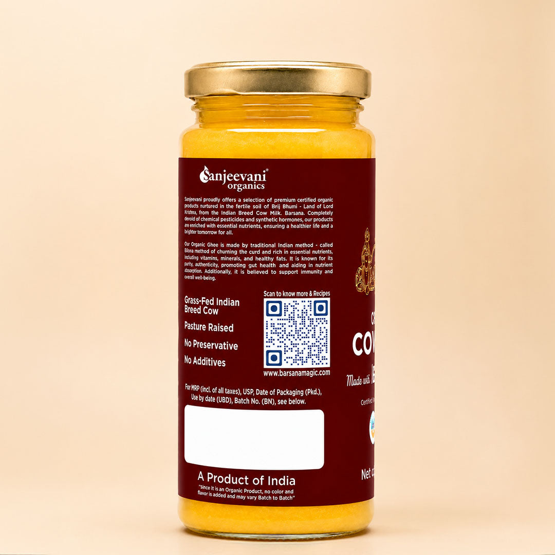 Barsana Magic and Sunjevani Organics Gran-Idi Indian Breed Cow pasture raised organic goat milk powder in a glass jar with a gold lid and dark red label, shown against a warm beige background.