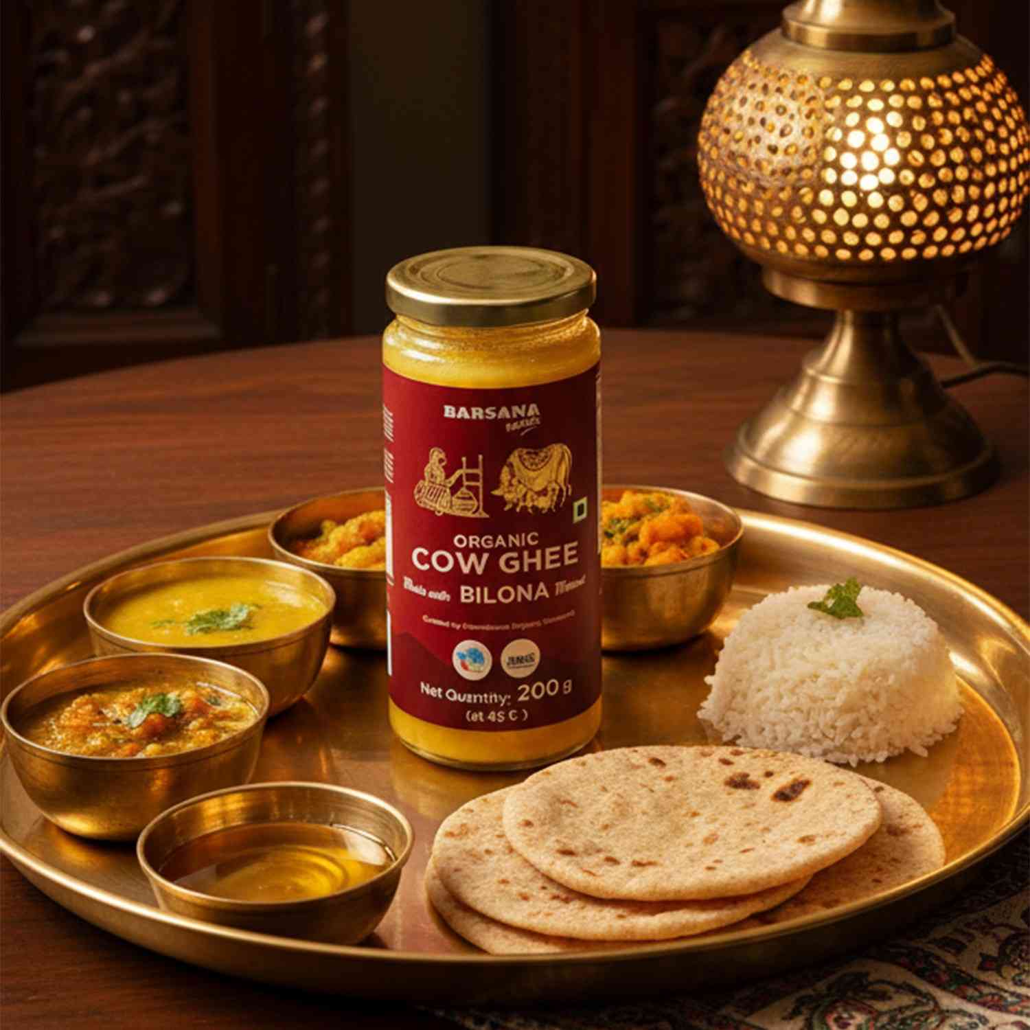 Barsana Magic and Jar of Barsana Organic Cow Ghee on a dining table with food items