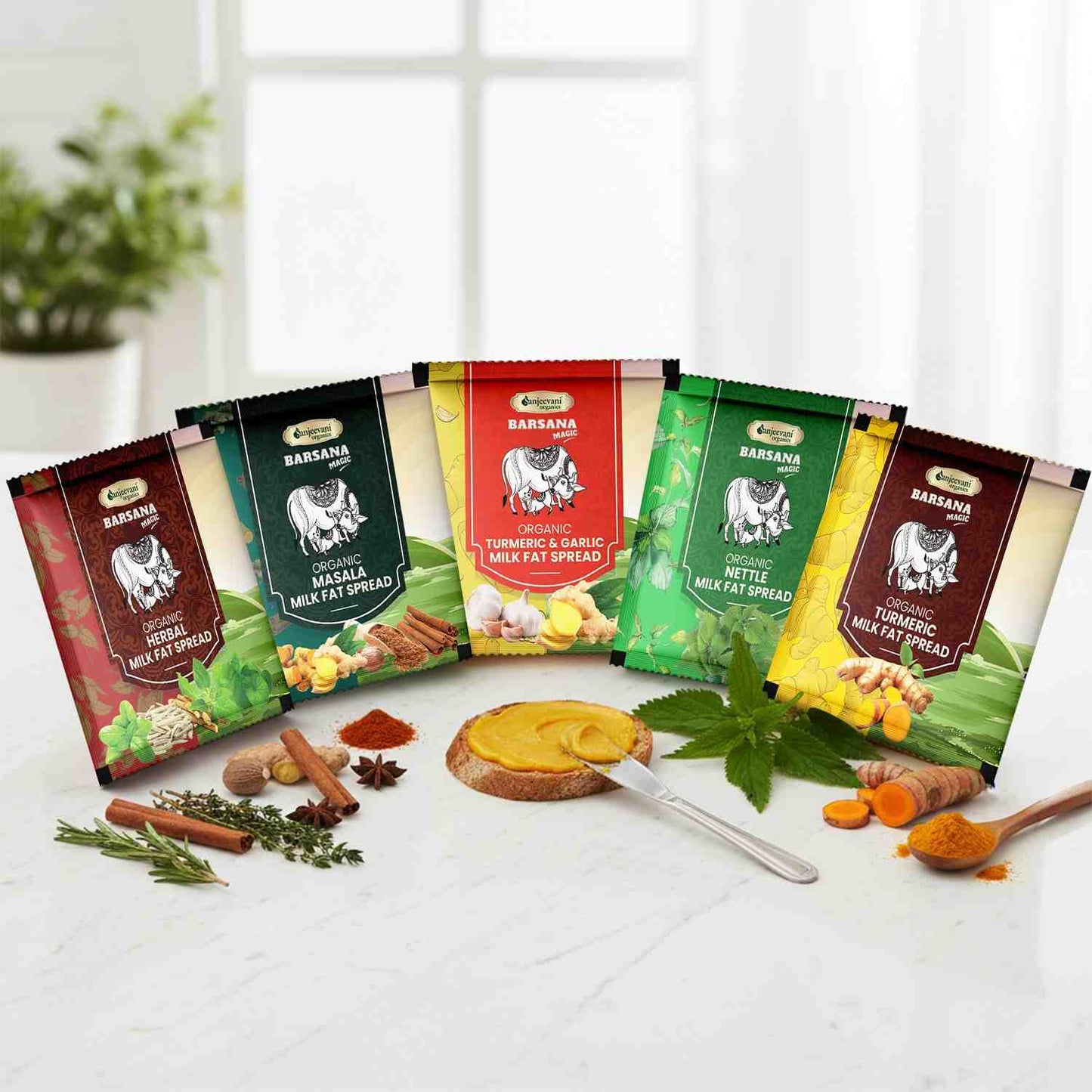 Barsana Magic and Assorted packages of Banana Organic spreads on a white surface with a blurred indoor background.