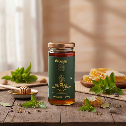 Barsana Magic and Jar of Van Tulsi Raw Honey on a wooden table with honeycomb and mint leaves.