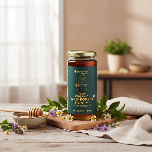 Barsana Magic and Jar of organic wild forest honey on a wooden table with flowers and a honey dipper.