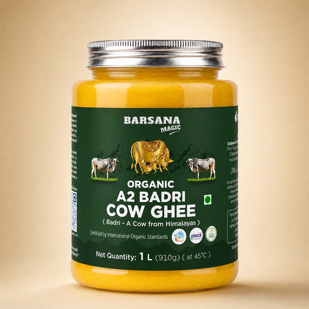 Barsana Magic and A 1-liter plastic jar of Barsana Magic Organic A2 Badri Cow Ghee, filled with yellow ghee and featuring a dark green label with cow illustrations, set against a solid beige background.