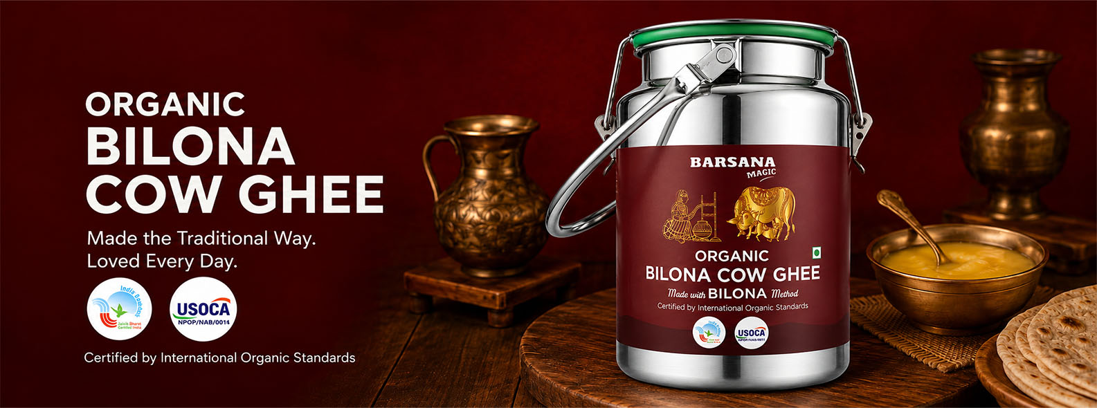 Barsana Magic and A canister of Barsana Organic Bilona Cow Ghee is displayed on a wooden table with traditional Indian cooking vessels and ingredients in the background. The left side of the image features a dark red banner with white text reading 'ORGANIC BILONA COW GHEE' and certification logos.