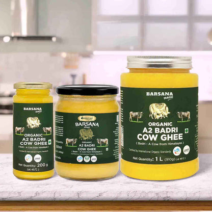 Barsana Magic and Three jars of Barsana Organic A2 Badri Cow Ghee on a kitchen counter.