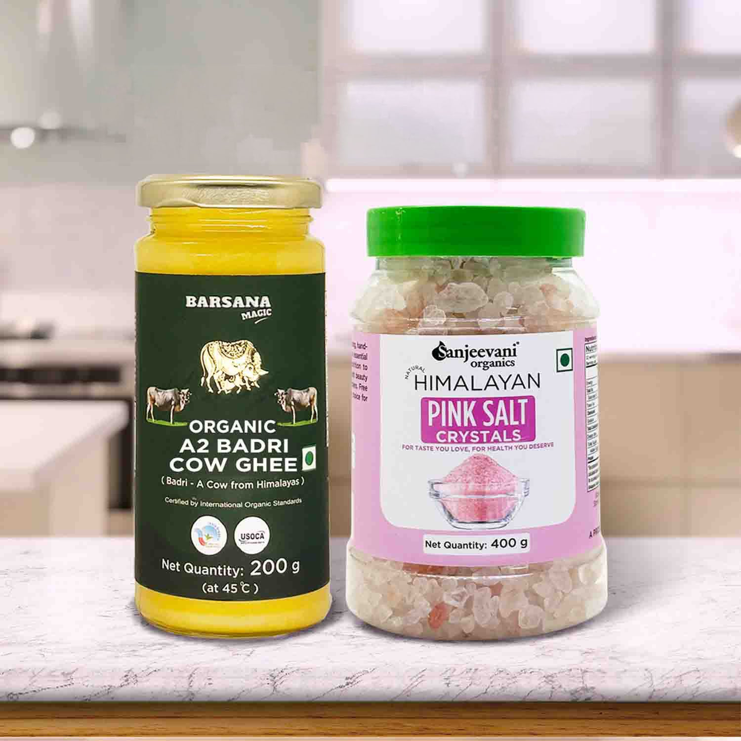 Barsana Magic and Two jars of organic ghee and pink salt crystals on a kitchen counter.