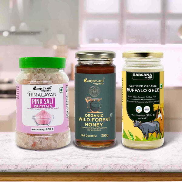 Barsana Magic and Three jars of Himalayan pink salt, organic wild forest honey, and certified organic buffalo ghee on a kitchen counter.