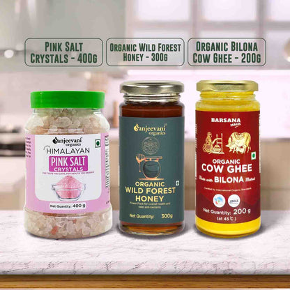 Barsana Magic and Three jars of organic products including pink salt, honey, and cow ghee on a kitchen counter.