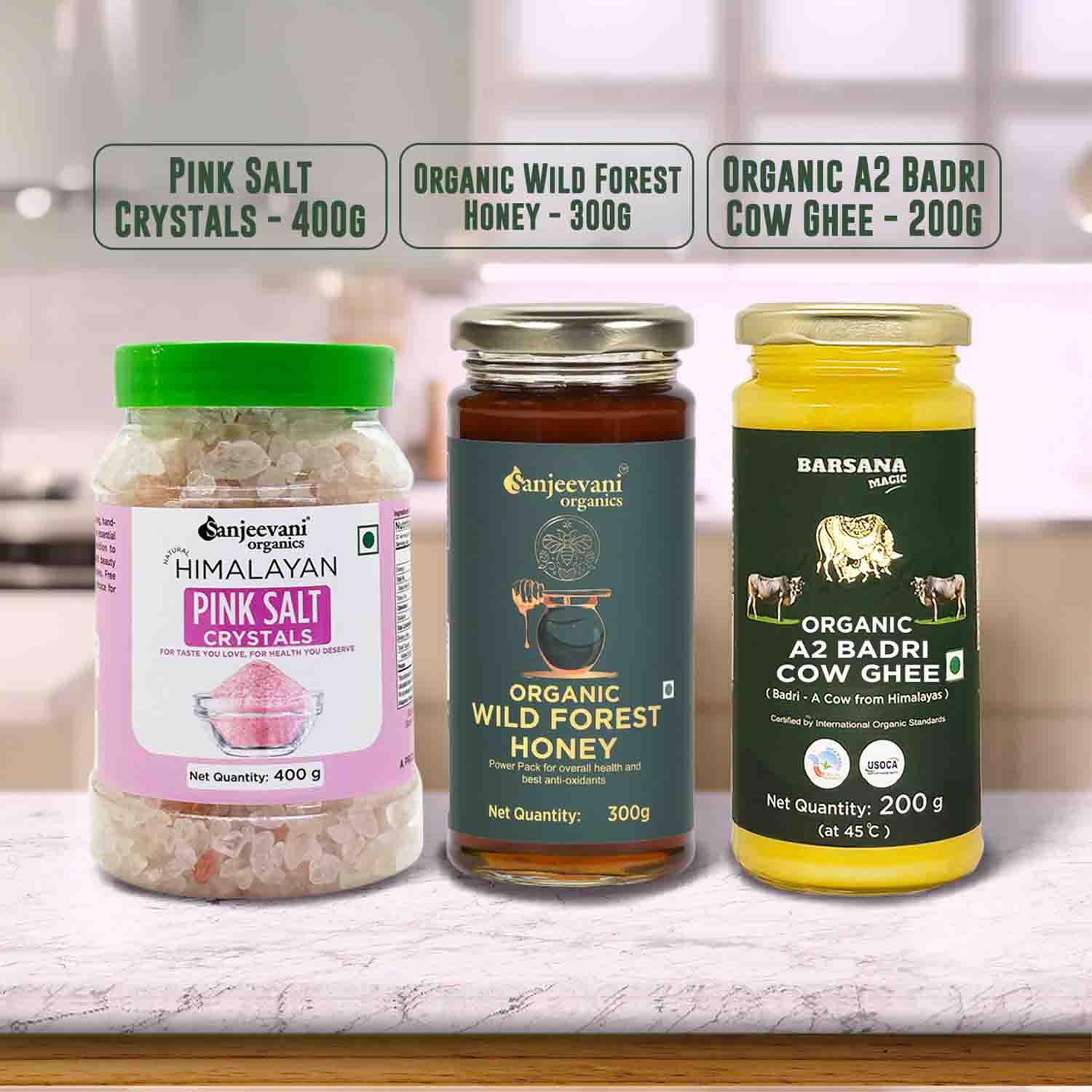 Barsana Magic and Three jars of organic products including pink salt, honey, and cow ghee on a kitchen counter.
