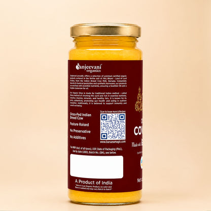 Barsana Magic and Sunjevani Organics Gran-Idi Indian Breed Cow pasture raised organic goat milk powder in a glass jar with a gold lid and dark red label, shown against a warm beige background.