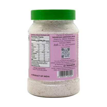 Barsana Magic and  Jar of salt with a pink label and green lid on a white background