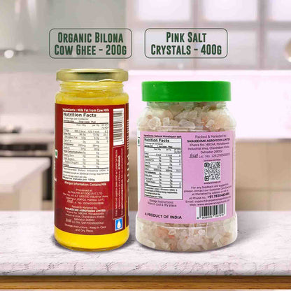 Barsana Magia and  Two jars labeled 'Organic Bilona Cow Ghee' and 'Pink Salt Crystals' on a kitchen counter.
