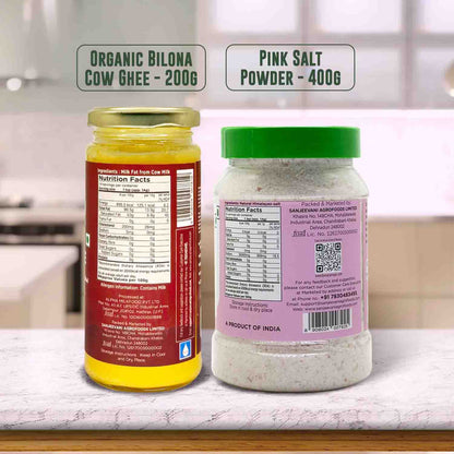 Barsana Magic and Two jars labeled 'Organic Bilona Cow Ghee' and 'Pink Salt Powder' on a kitchen counter.