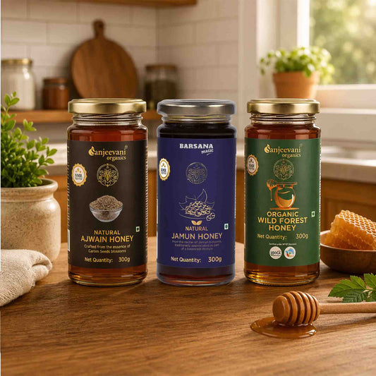Barsana Magic and Three jars of honey from different brands on a kitchen counter with a honey dipper.