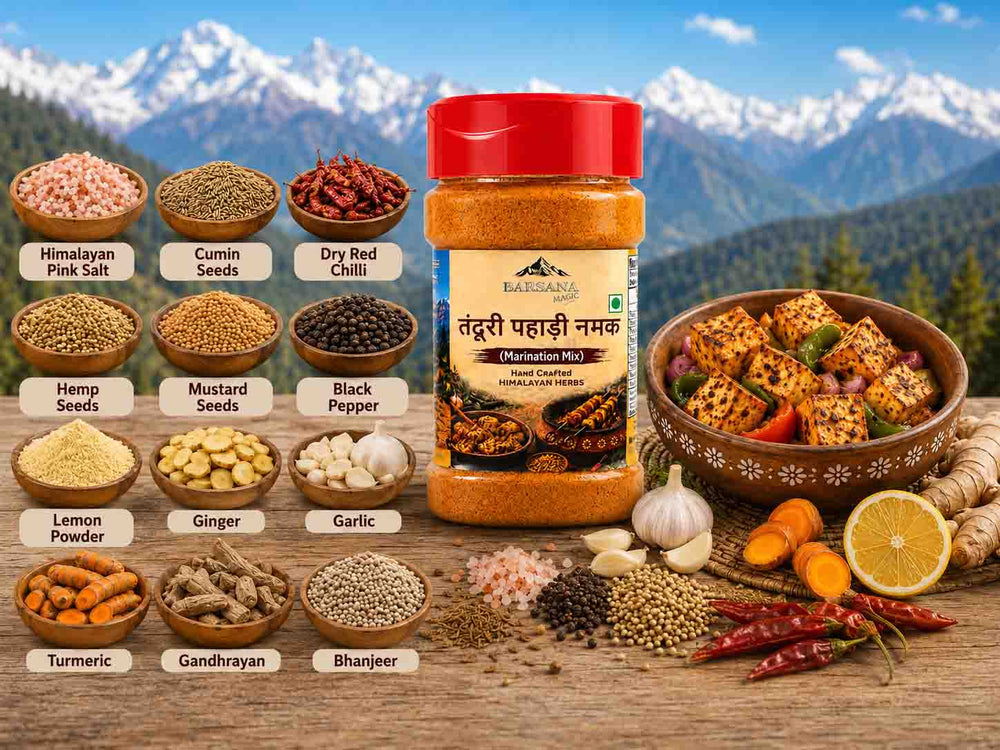 Barsana Magic and A jar of BARKANA Tendu Pahaaki Namak (marinated pickle) displayed on a wooden table with various ingredients like pink salt, cumin seeds, dry red chili, mustard seeds, black pepper, ginger, garlic, turmeric, and bharjee. A bowl of prepared marinated pickle is shown on the right, set against a background of mountains and forests.