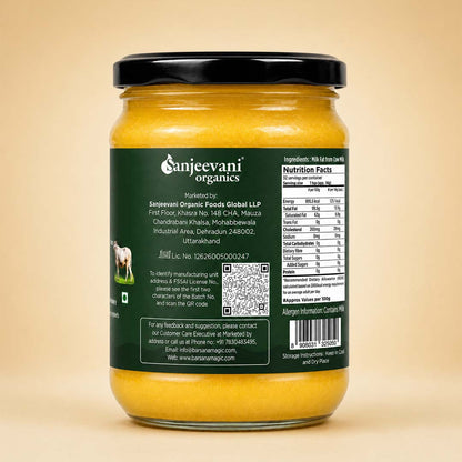 Barsana Magic and A jar of Sanjeevani Organics Garam Masala Spice Mix, showing the back of the dark green label with product details, nutrition facts, and a barcode, set against a solid beige background.
