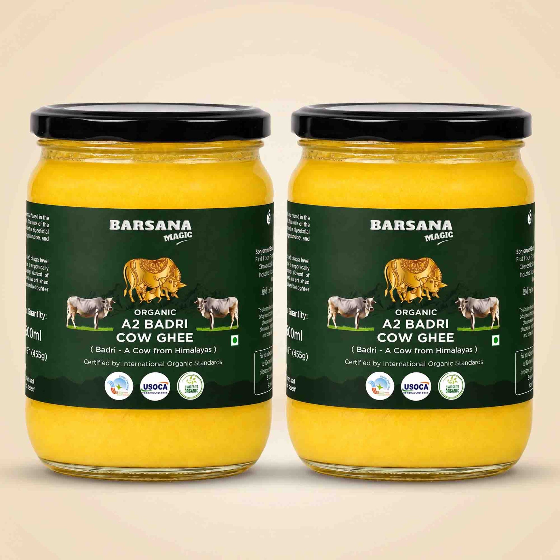 Barsana Magic and Two glass jars of A2 Badri Cow Ghee with black lids and dark green labels, displayed side-by-side on a light beige background.