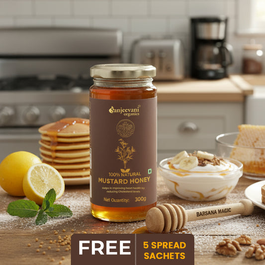Barsana Magic and Jar of Sanjeevani Organics mustard honey on a kitchen counter with pancakes, lemons, and other items.