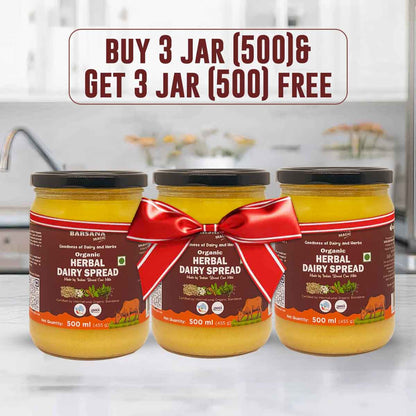 Barsana Magica and Three jars of organic herbal dairy spread with a red bow on a kitchen counter.