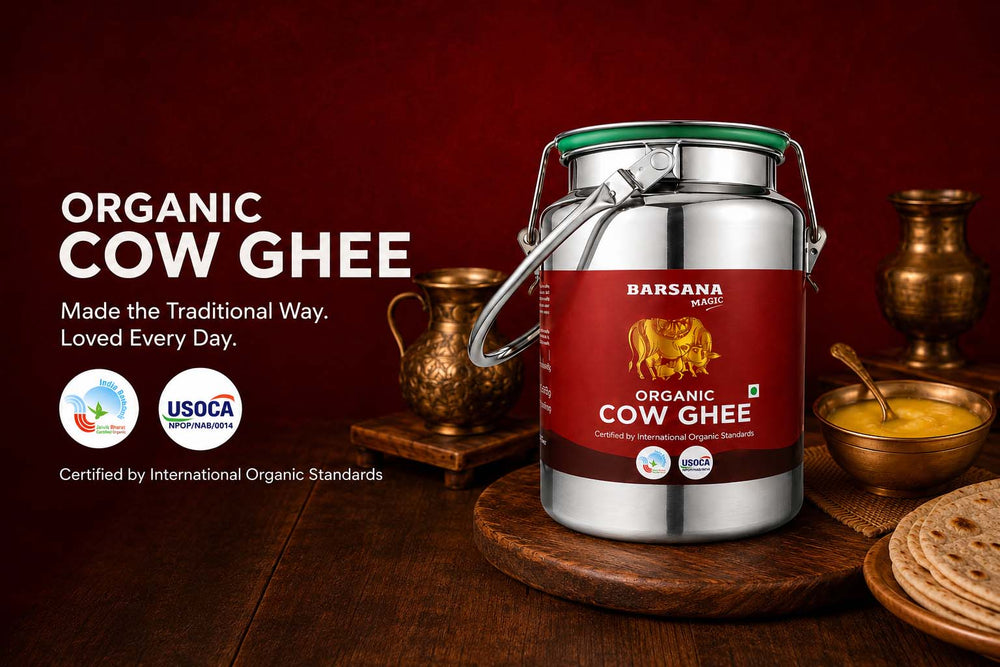 Barsana Magic and A large stainless steel container of Barsana Organic Cow Ghee on a wooden stand, surrounded by traditional Indian serving vessels, a bowl of yellow ghee, and flatbread against a dark red background.