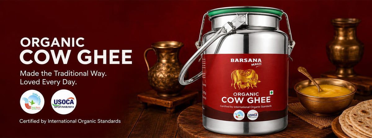 Barsana Magic and A large metal canister of Barsana Organic Cow Ghee is shown on a rustic wooden table with traditional copper vessels and a bowl of yellow ghee in the background. The left side features promotional text, certification logos, and the Barsana brand name.