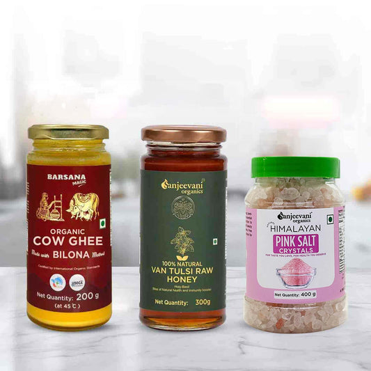 Barsana Magic and Three jars of organic products including cow ghee, van tulsi raw honey, and pink salt crystals on a white background.