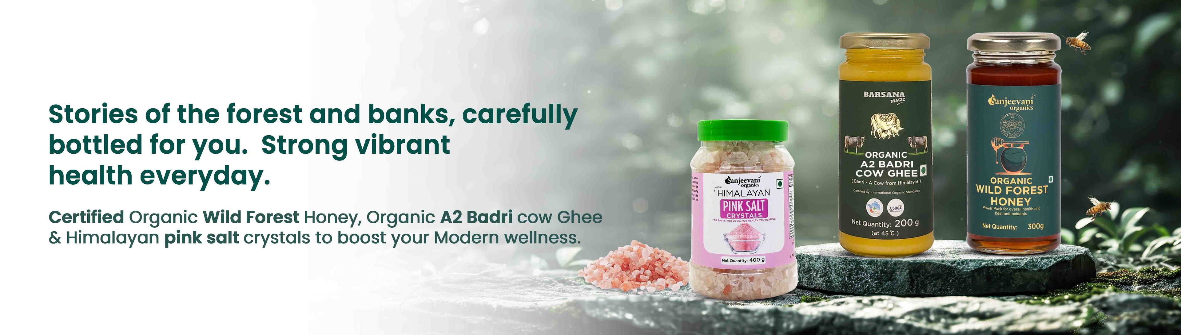 Barsana Magic and Three jars of honey and a container of salt on a stone surface with a natural background.