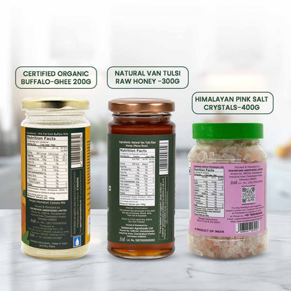 Barsana Magic and  Three jars with labels for Certified Organic Buffalo Ghee, Natural Van Tulsi Raw Honey, and Himalayan Pink Salt Crystals on a white background.