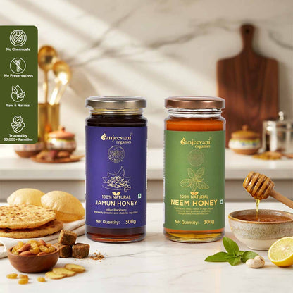 Barsana Magic and Two jars of honey from Sanjeevani Organics on a kitchen counter with food items around.
