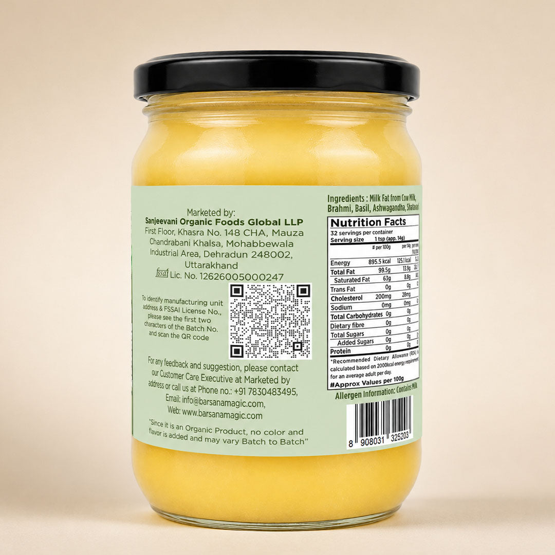 Barsana Magic and A glass jar of yellow butter with a black lid, showing the back label with text, a QR code, and nutrition facts against a plain beige background.