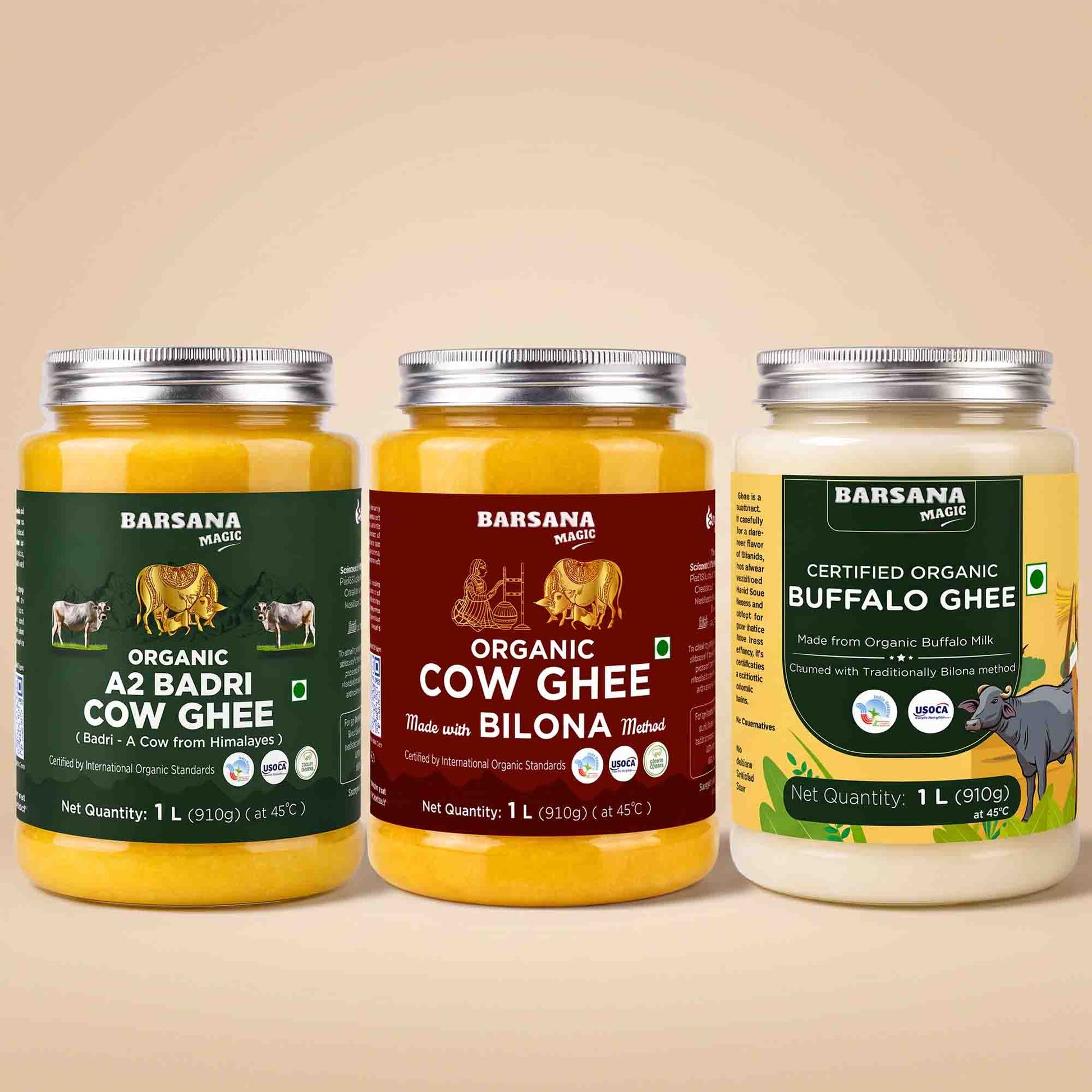Barsana Magic and Three jars of Barsana Magic brand ghee arranged side by side on a warm beige background. The left jar is Organic A2 Badri Cow Ghee with a dark green label; the middle jar is Organic Cow Ghee made with Bilona butter, with a dark red label; the right jar is Certified Organic Buffalo Ghee with a yellow and green label.