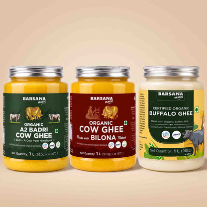Barsana Magic and Three jars of Barsana Magic brand ghee arranged side by side on a warm beige background. The left jar is Organic A2 Badri Cow Ghee with a dark green label; the middle jar is Organic Cow Ghee made with Bilona butter, with a dark red label; the right jar is Certified Organic Buffalo Ghee with a yellow and green label.
