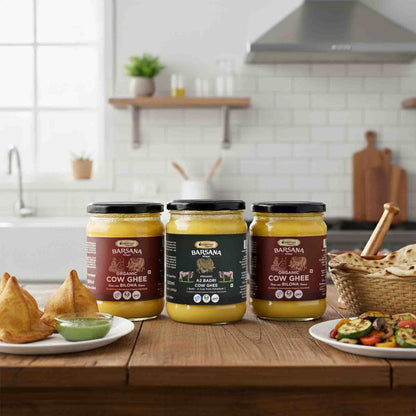 Barsana Magic and Three jars of ghee on a kitchen counter with food items around