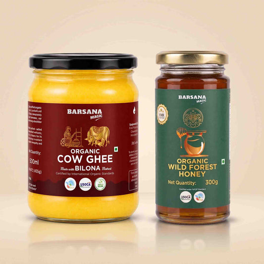 Barsana Magic and Two glass jars of Barsana brand organic ghee and honey on a light beige background. The left jar contains yellow organic cow ghee with a black lid and dark red label.