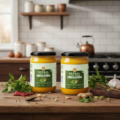Barsana Magic and Two jars of Herbal Cow Ghee on a kitchen counter with spices and herbs.