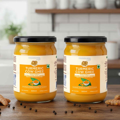 Barsana Magic and Two jars of Turmeric Cow Ghee on a wooden surface with a blurred kitchen background.