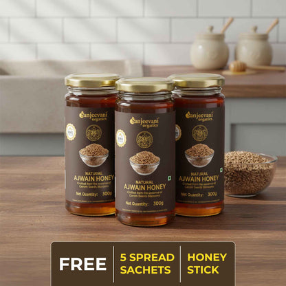 Barsana Magic and Three jars of Ajwain honey on a wooden table with a kitchen background.