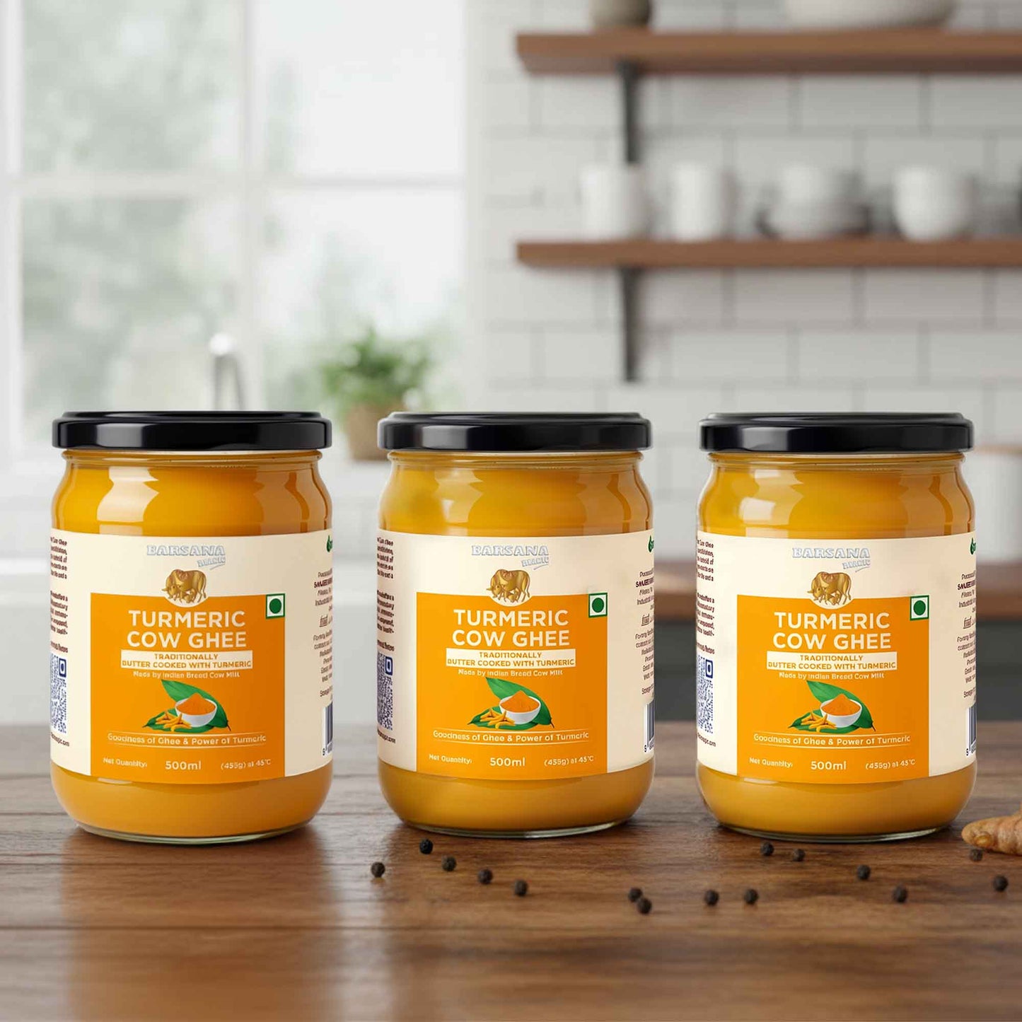 Barsana Magic and Three jars of Turmeric Cow Ghee on a wooden surface with a kitchen background.