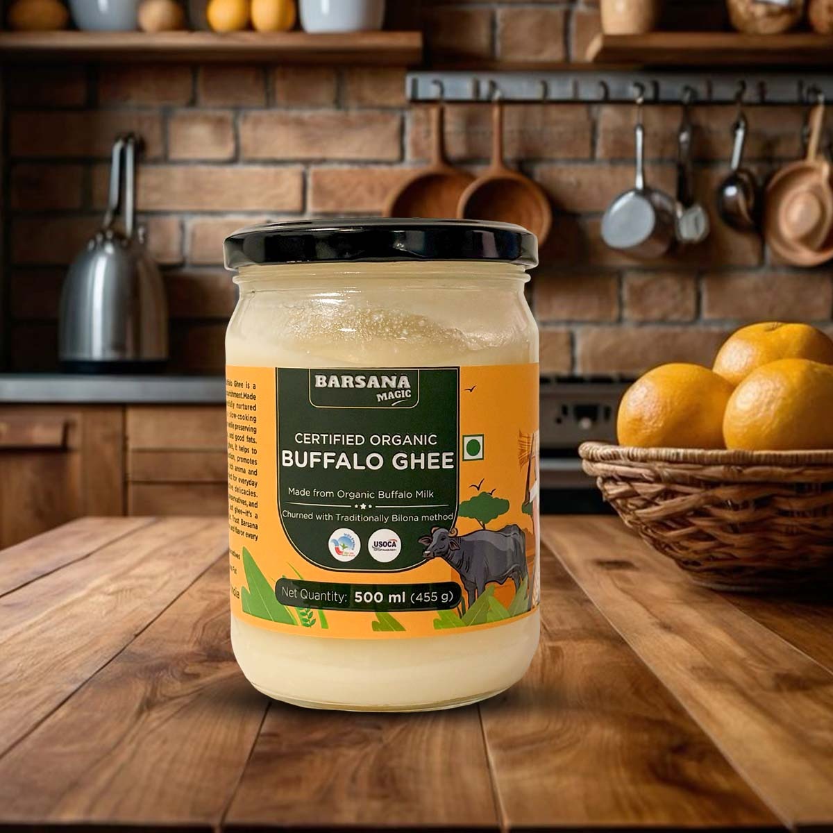 Barsana Magic and Jar of Barsana Organic Buffalo Ghee on a wooden kitchen counter with a brick wall background.