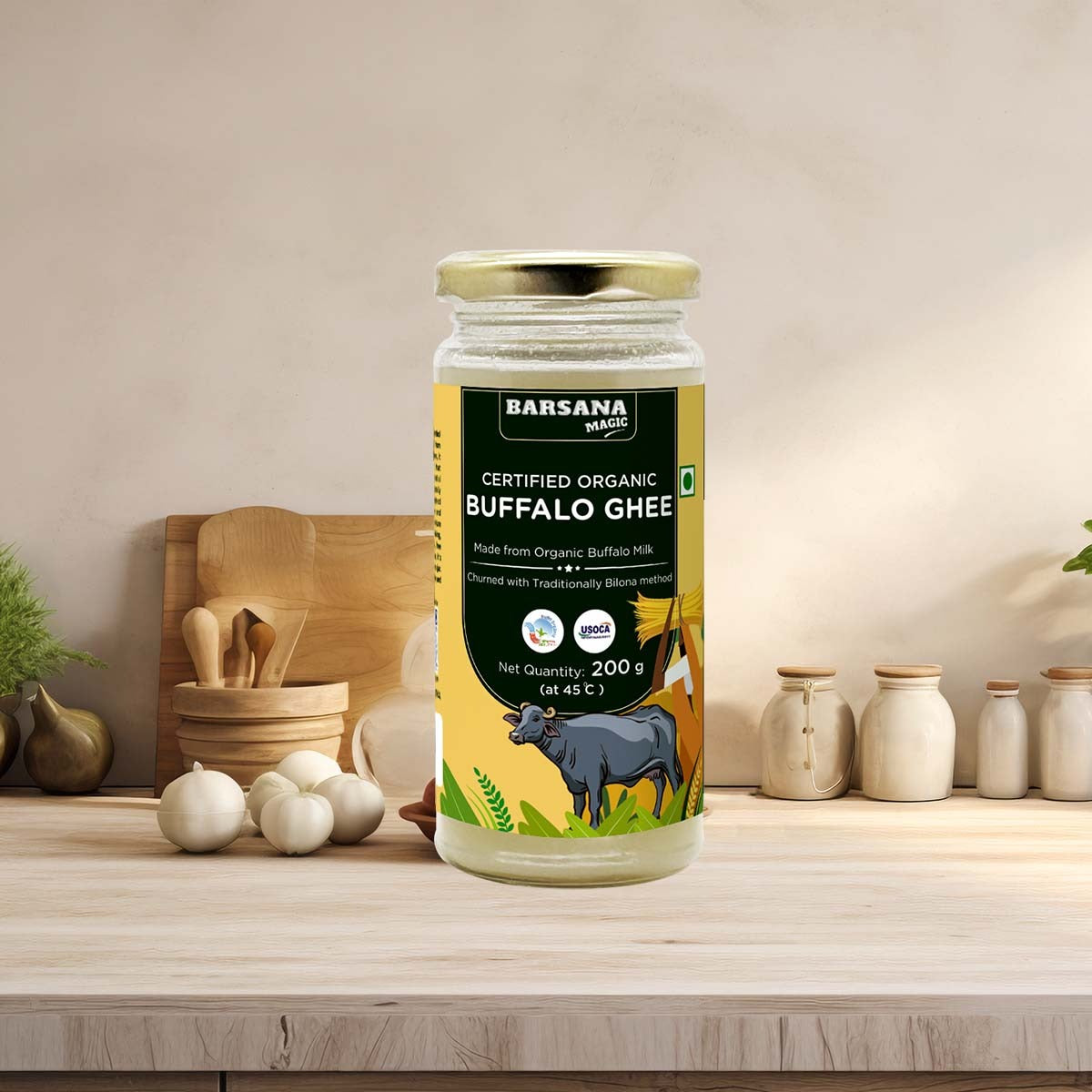 Barsana Magic and Jar of Barsana Certified Organic Buffalo Ghee on a kitchen counter with decorative items.
