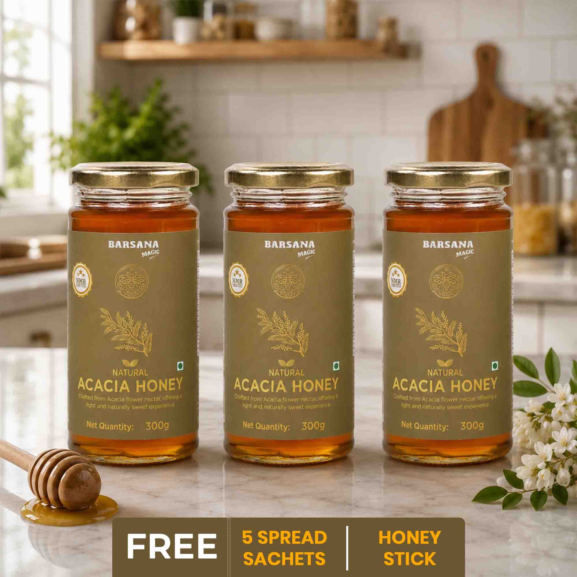 Barsana Magic and Three jars of Acacia Honey on a kitchen counter with a honey dipper and flowers.