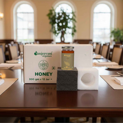 Barsana Magic and Organics honey jar and packaging on a table in a room with large windows.