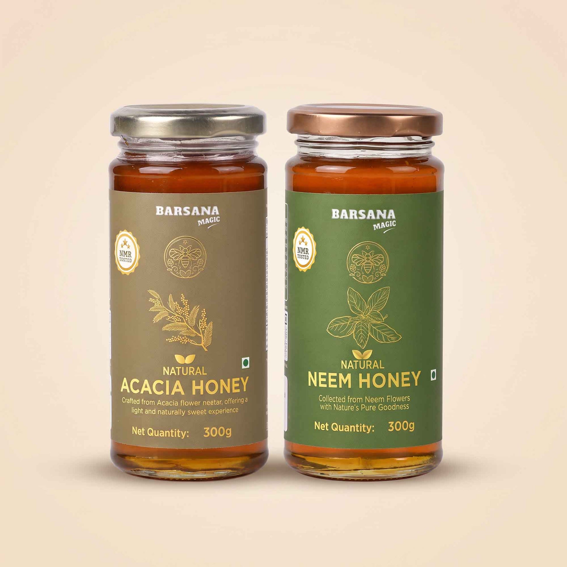 Barsana Magic and Two glass jars of Barsana Magic honey, Natural Acacia Honey on the left with a brown label and silver lid, and Natural Neem Honey on the right with a green label and bronze lid, set against a solid beige background.