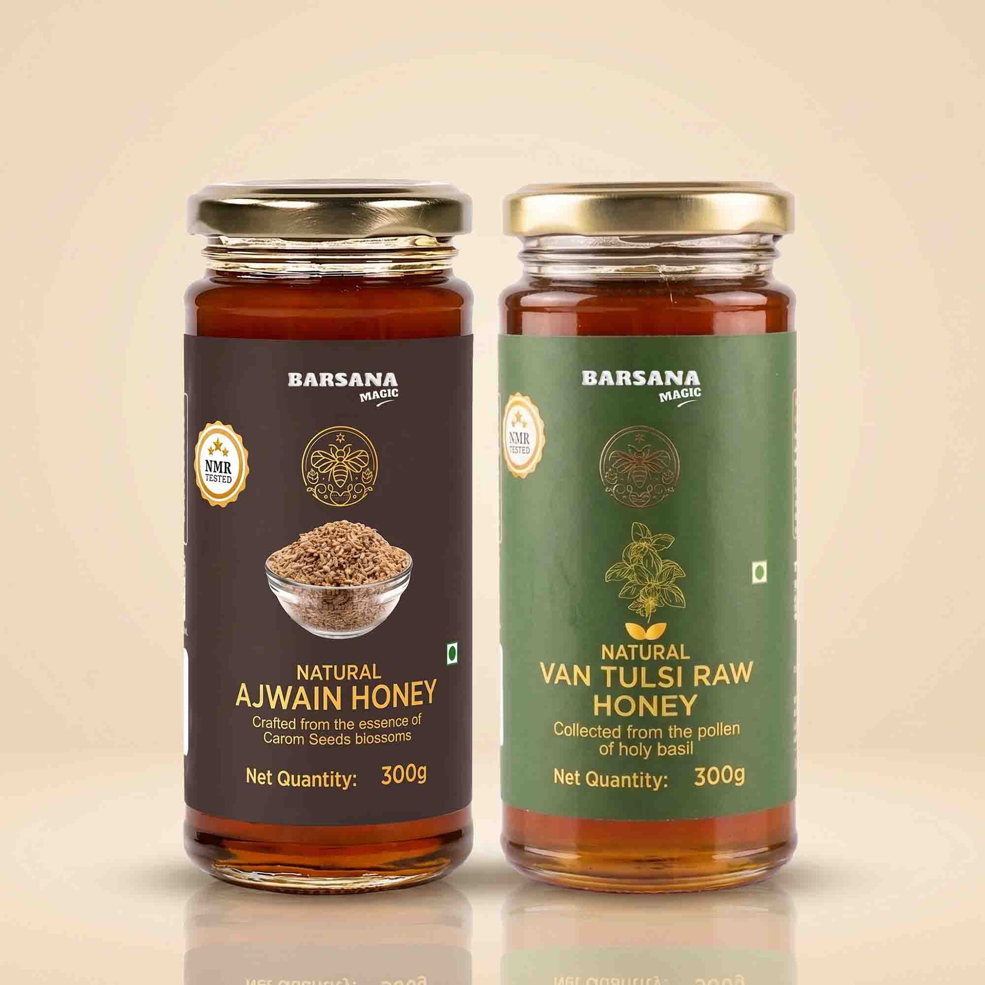 Barsana Magic and Two glass jars of Barsana Magic honey on a beige background. The left jar is labeled 'Natural Ajwain Honey' with a dark brown label, and the right jar is labeled 'Natural Van Tulsi Raw Honey' with a green label.