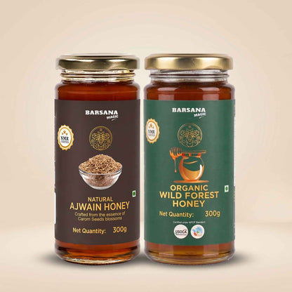 Barsana Magic and Two glass jars of Barsana Magic honey on a beige background. The left jar is labeled 'Natural Ajwain Honey' with a dark brown label and gold lid.