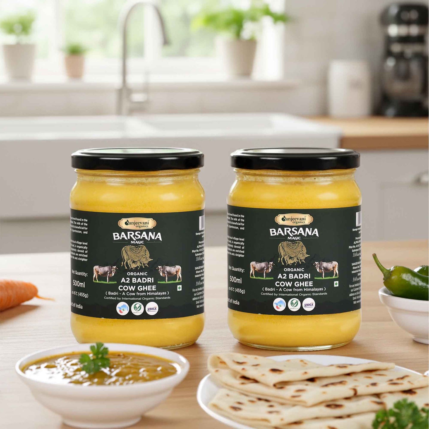 Barsana Magic and Two jars of Cow Ghee on a kitchen counter with food items around