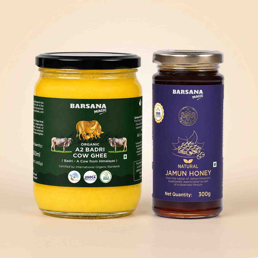 Barsana Magic and Two jars of Barsana Magic spreads on a light beige background: a large jar of Organic Az Badri Cow Ghee with a black lid and dark green label, and a smaller jar of Natural Jamun Honey with a silver lid and dark purple label.