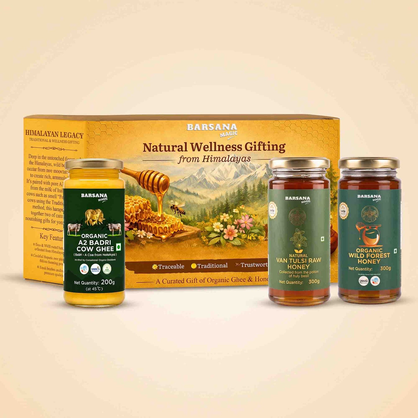 Barsana Magic and Natural Wellness Gifting set featuring a large golden-yellow box, a jar of organic AS Badhi Cow Ghee, and two jars of honey (Van Tulsi Raw Honey and Organic Wild Kept Honey) arranged in front of the box on a light beige background.