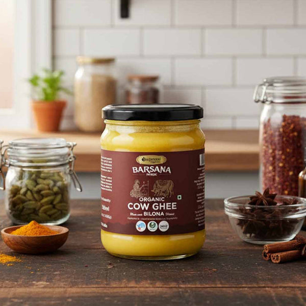 Barsana Magic and Jar of Organic Cow Ghee on a kitchen counter with various spices and ingredients.