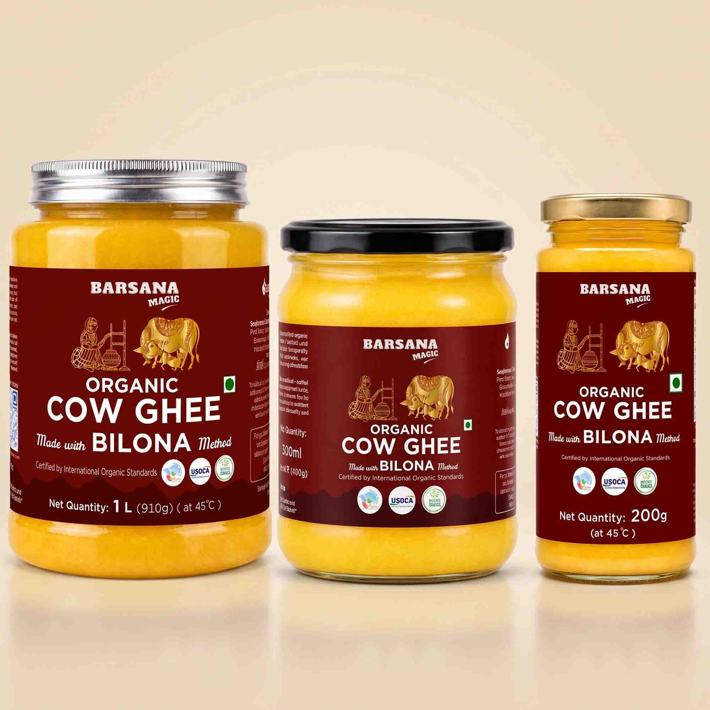 Barsana Magic and Three glass jars of Barsana Organic Cow Ghee arranged side by side on a light beige background. The left jar has a silver lid, the middle has a black lid, and the right has a gold lid.