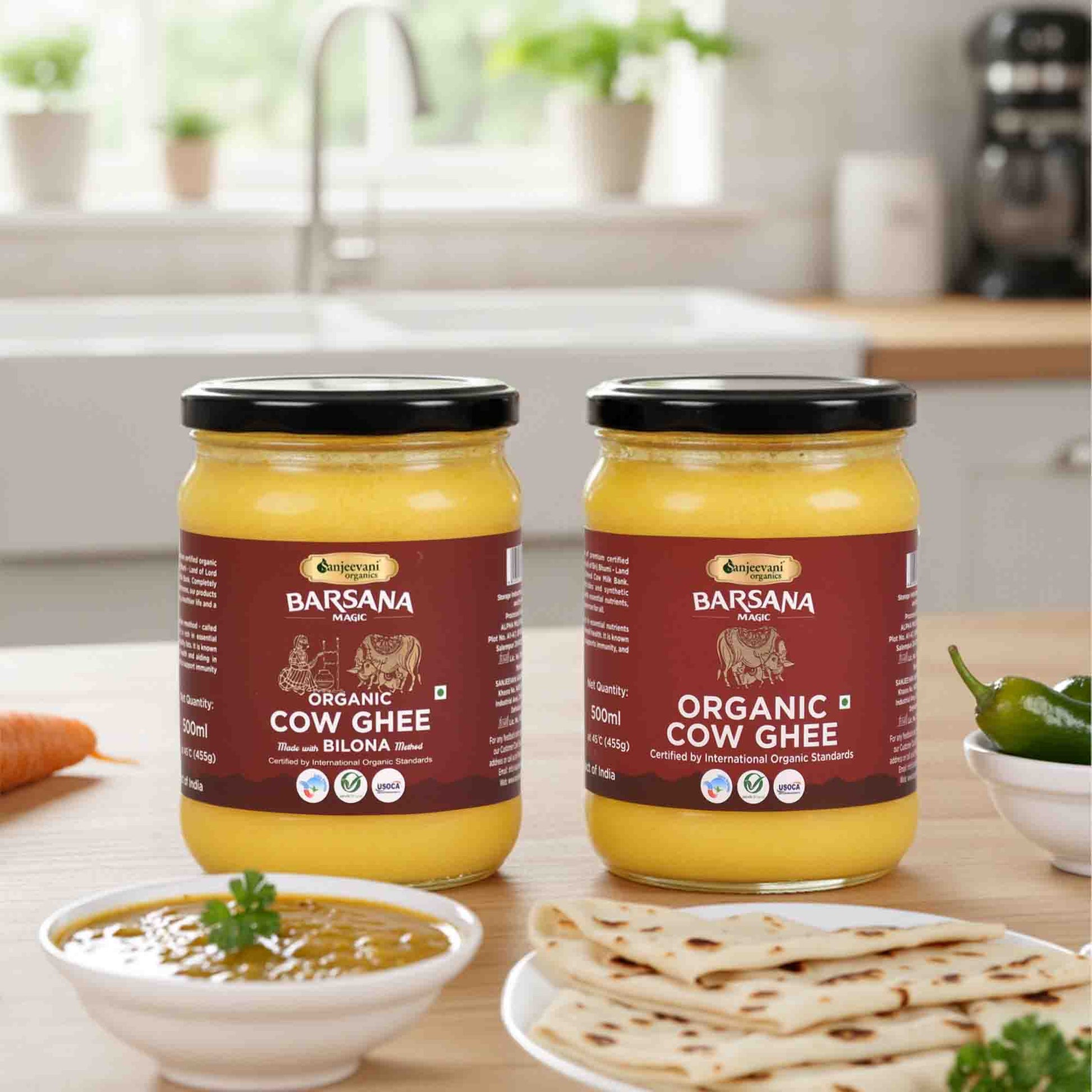 Barsana Magic and Two jars of Organic Cow Ghee on a kitchen counter with food items around.